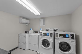 A row of washing machines in a laundry room.